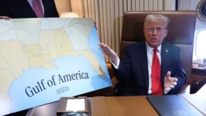 Donald Trump in Oval Office. He's showing off a map with 'Gulf of America' on it. (Rebranded 'Gulf of Mexico')